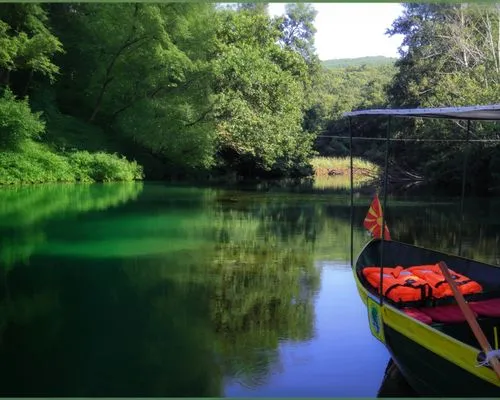 a boat in a green lake,a boat that is sitting in the water,the danube delta,giverny,danube delta,cenote,king decebalus,wekiva,decebalus,loboc,wachee,cenotes,green water,bihac,riverine,amazonia,wimberl