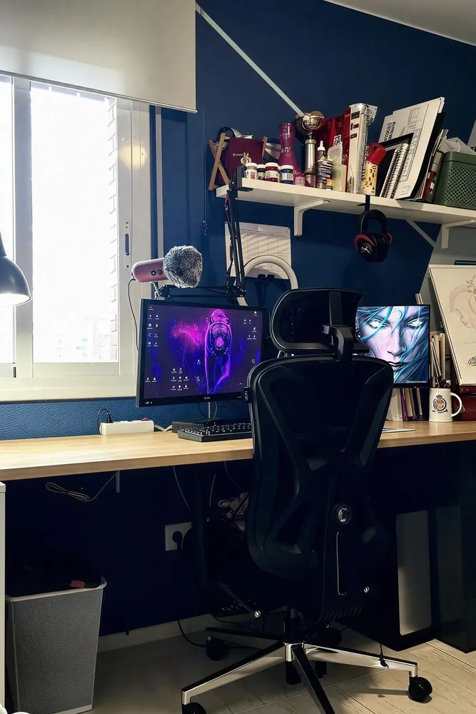 office area with a desk, chairs, and various supplies on the desk
