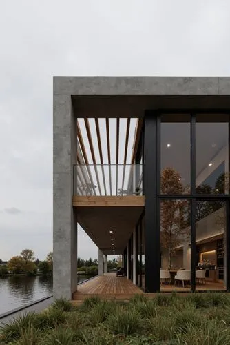 A photo-realistic rendering of a modern, minimalist house with a minimalist design. the house is situated on the shore of a lake, with a serene and peaceful atmosphere. the building is a two-story str