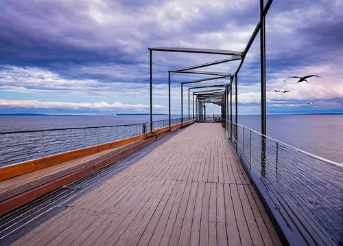 Duluth MN, Lake Superior waterfront, modern architecture, glass façade, steel beams, cantilevered roofs, geometric shapes, urban landscape, cityscape, scenic views, pedestrian walkway, lake pier, sail