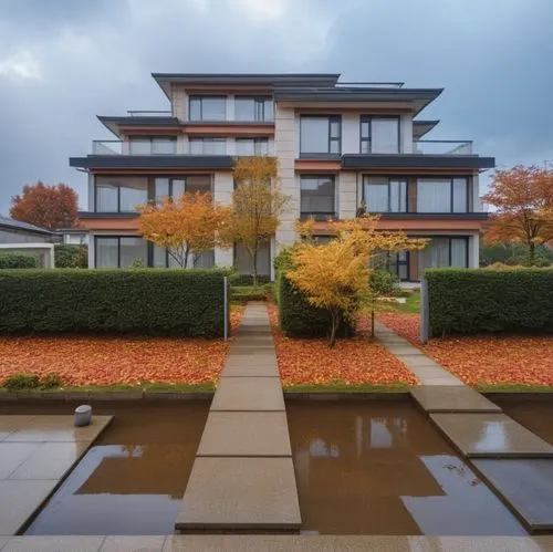 a beautiful building with water and trees in front,landscaped,house with lake,house by the water,fall landscape,mahtomedi,autumns