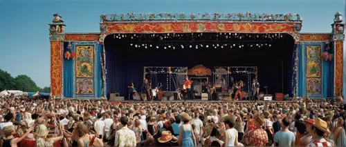 Create a scene of a concert stage during a summer festival with vibrant decorations and a lively crowd.,circus stage,waldbühne,tomorrowland,circus tent,music festival,gypsy tent,stage curtain,circus s