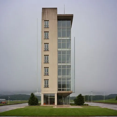 a tall building with many windows, in the middle of a field,office building,residential tower,undersecretariat,new building,modern building,headquarter,Photography,General,Realistic
