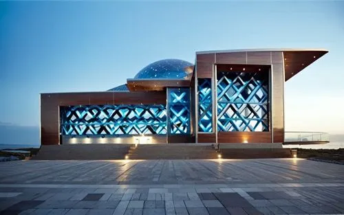 a building with two dome like windows on the side,islamic architectural,star mosque,hassan 2 mosque,house of the sea,christ chapel,glass facade,mahdavi,the observation deck,otaru aquarium,kaust,irania