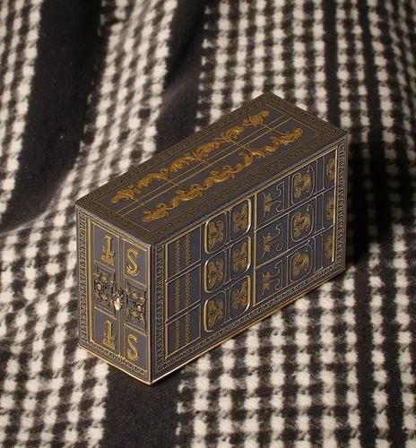 a small box that is on a bed,chess cube,card box,wooden cubes,cube surface,game blocks,index card box,game dice,magic cube,dice for games,wooden box,vinyl dice,pen box,cubes games,lyre box,matchbook,l