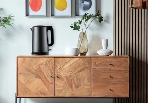 An electric kettle,credenza,sideboard,wooden shelf,highboard,sideboards,chest of drawers,wood casework,wooden desk,mid century modern,bentwood,limewood,danish furniture,patterned wood decoration,stora