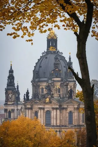 Dresden Frauenkirche, Baroque architecture, ornate details, intricate stone carvings, grand dome, yellow-brown stone walls, stained glass windows, Gothic Revival influences, picturesque surroundings, 