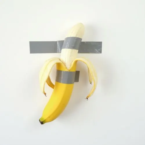 banana peal  is taped with two grey stripes adhesive tapes to a white wall, ,there is a small banana taped to the wall,banana,monkey banana,banane,banan,bananafish,bananarama,potassium,banana apple,na