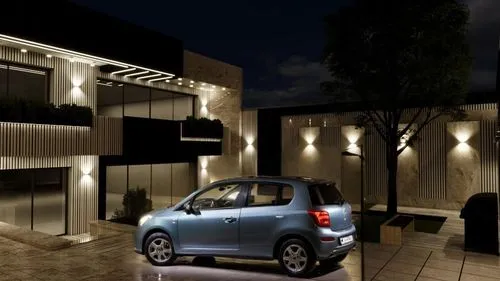 Changing the angle of the car relative to the garden ,a small blue car parked next to a building at night,car showroom,fiat 500,electric charging,night shot,night photo,night photograph,photo session 