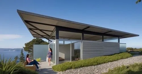 woman,two people standing outside a small house on the ocean,dunes house,cubic house,smart house,folding roof,inverted cottage,cantilevered,prefab,summer house,house by the water,cube house,cantilever