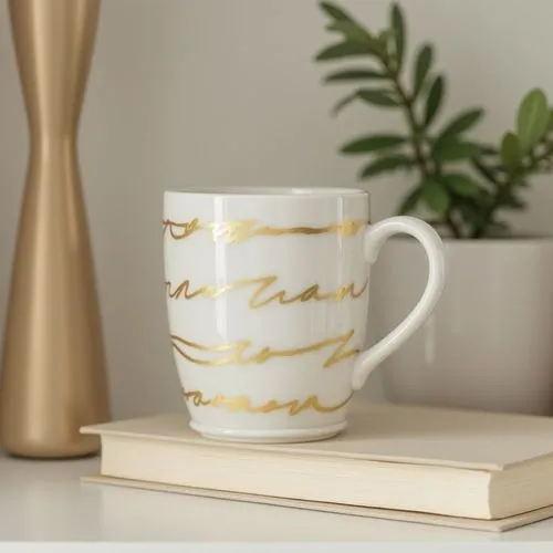 shelf addition to the living room, white cup decoration with gold stripes , beige book, modern,a coffee mug on top of a book,printed mugs,gold foil laurel,coffee mugs,coffee mug,gold foil corner,coffe