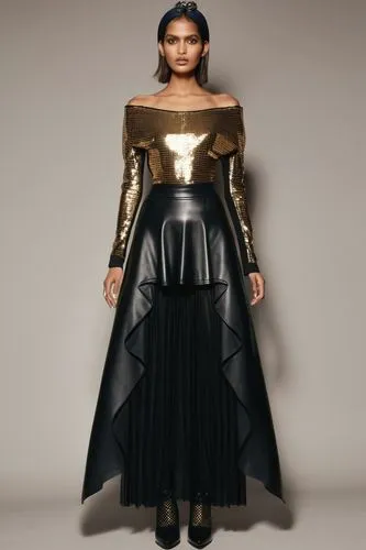 a fashion model  wearing off gold and black shoulder top, maxi skirt and boots,woman in black and gold leathers dress in studio,dress walk black,allude,refashioned,foiling,foils,metallic feel,gold foi