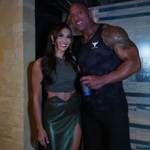 the rock and his girlfriend are posing together,bodybuilders,reigns,black couple,aliyah,muscular,edge muscle,undertaker,pair of dumbbells,date night,herculean,bodyguard,incredible hulk,hulks,steroids,