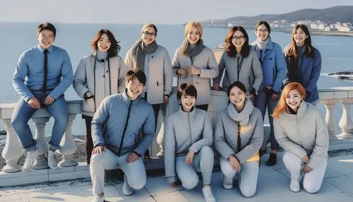 the group of students and teachers pose for a po on a roof,propounds,rowing team,tracksuits,sweatsuits,island group,stewardesses