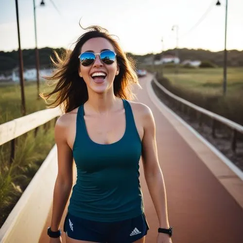 a woman in sunglasses is standing on a path,female runner,endorphins,free running,endorphin,running,jogging,sprint woman,jogs,run uphill,jog,sports exercise,marathoner,jogged,a girl's smile,exercisers