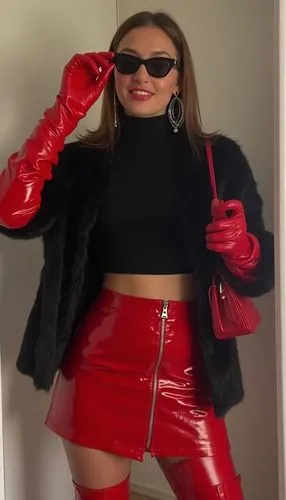 Quick, spontaneous mirror selfie video: She flexes her ultra-long gloves, slowly adjusting the fingers to make them look even more striking. She wears bright red thigh-high chunky platform boots with 