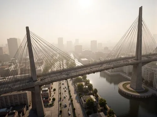 Sleek suspension bridge, curved steel cables, sturdy piers, cantilevered roadways, modern angular architecture, urban cityscape, misty morning atmosphere, soft warm lighting, shallow depth of field, 3