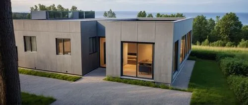 two modern houses on the side of a grassy area,cubic house,cube house,prefab,modern house,inverted cottage,danish house,prefabricated,dunes house,cube stilt houses,render,smart house,modern architectu