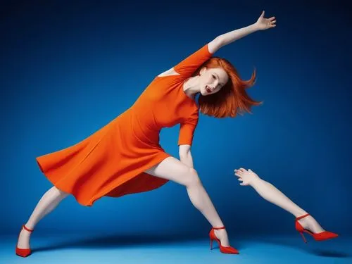 The image shows a fierce redhead with straight mid-length bob hair in vibrant orange hues, leaning forward and leaning forward. She now leans towards her feet, her hair barely visible beneath her body