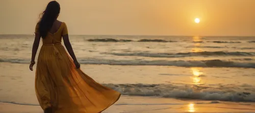 Kerala girl. Age 20. Wearing a long dress.  Walking towards sea. Beach side. Golden hour. High frame rate. 4k. High quality.,golden sands,golden sun,girl in a long dress from the back,sun and sea,girl
