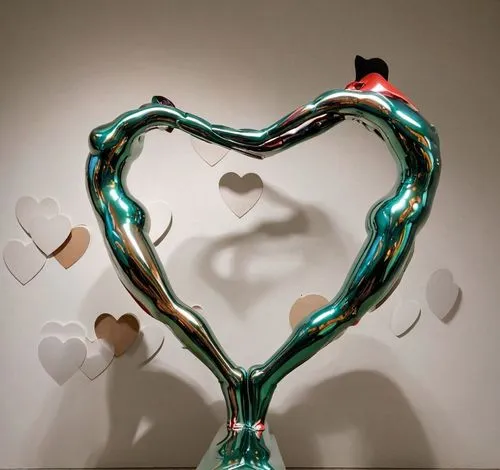 a sculpture representing a man and a woman leaning back to back to form a heart shape,an artistic display of different types of heart shapes,painted hearts,heart balloons,allies sculpture,heart balloo