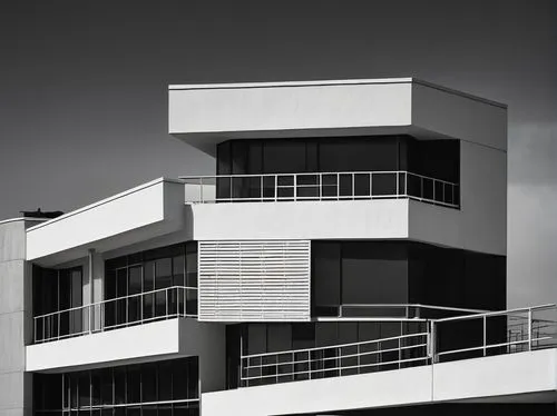 Bauhaus architecture, modernist style, clean lines, minimal ornamentation, rectangular forms, large windows, flat roof, white walls, steel beams, functional simplicity, urban setting, cityscape, bruta