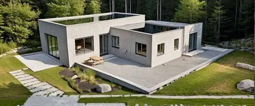 a modern building sitting on top of a lush green field,cubic house,inverted cottage,modern house,cube house,prefab,modern architecture,frame house,folding roof,prefabricated,forest house,chalet,reside