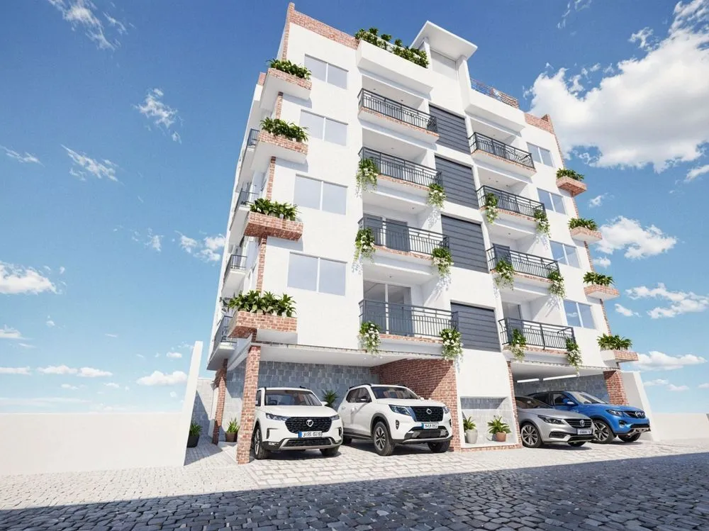 a modern white building has three car parks in front