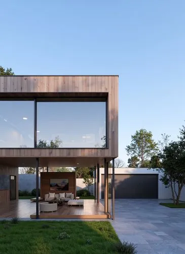 A modern house with a minimalist design, featuring a large glass wall and wooden cladding, set against a clear blue sky. the house is situated on a grassy area, with a concrete driveway leading up to