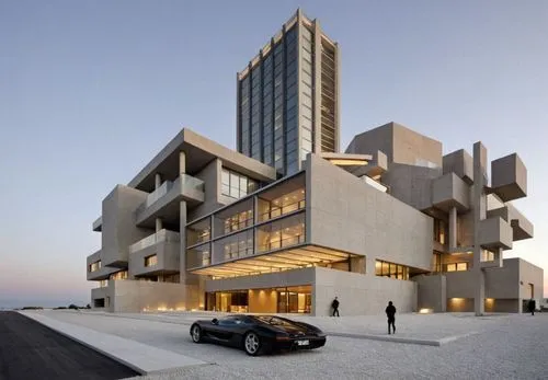 a building on a street corner and a black car parked in front,cubic house,modern architecture,dunes house,cube house,habitat 67,modern building,contemporary,building honeycomb,residential tower,cube s