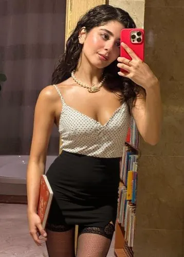 a woman posing next to books holding a red phone,see thru,gia,siana,latina,vestido,petite,vintage angel,minidress,mirror,ln,fishnets,party dress,blurriness,bodysuit,sc,hii,zeina,mpm,gabi,tetas
