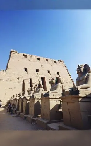 a view of statues of ancient egyptian gods and the temple,step pyramid,eastern pyramid,tracked armored vehicle,pharaohs,valley of the kings,stone pyramid
