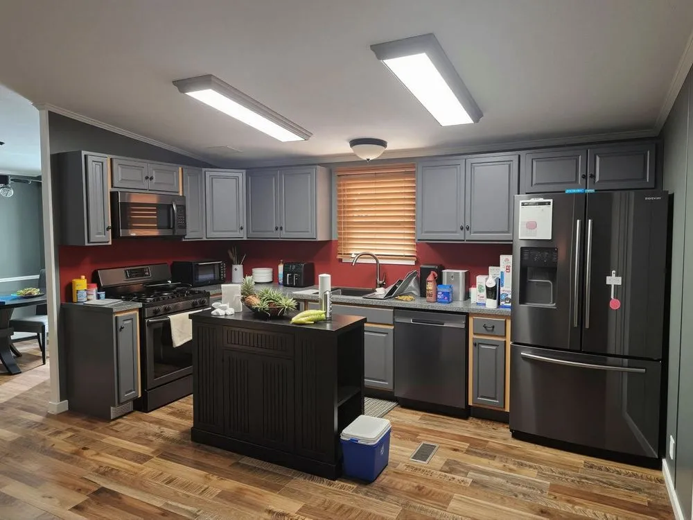 a kitchen that is under a light over a stove
