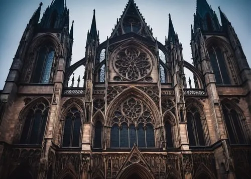 Gothic cathedral, grandiose, pointed arches, ribbed vaults, flying buttresses, stained glass windows, intricate stone carvings, gargoyles, tall spires, grand entrance, ornate doorways, mystical atmosp