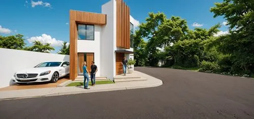 PHOTOGRAPH TAKEN WITH A KODAK CAMERA, WITH A 35MM LENS of a modern two-story house with a contemporary design. the house has a white exterior with wooden accents, and a large glass window on the secon
