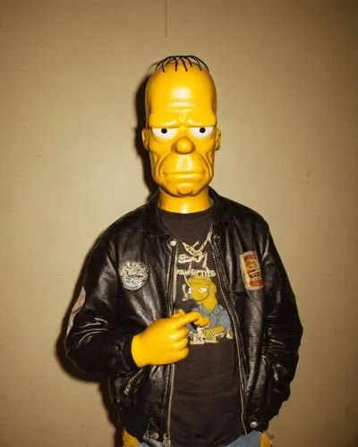 Homero Simpson con camiseta negra y chaqueta de cuero, realista,the statue is next to a wall with a smiley face,action figure,yellow jacket,plastic model,model train figure,collectible doll,a wax dumm