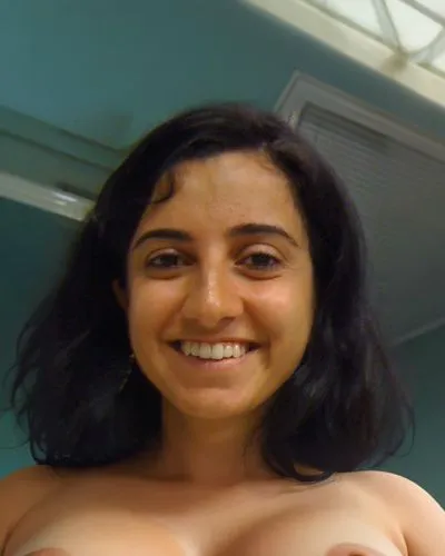 a naked middle-aged woman. she's short. she's a little plump. she has very large breasts. her breasts are sagging. she has big ass. she has thick thighs. she has a bald vagina. she has a pot belly. sh