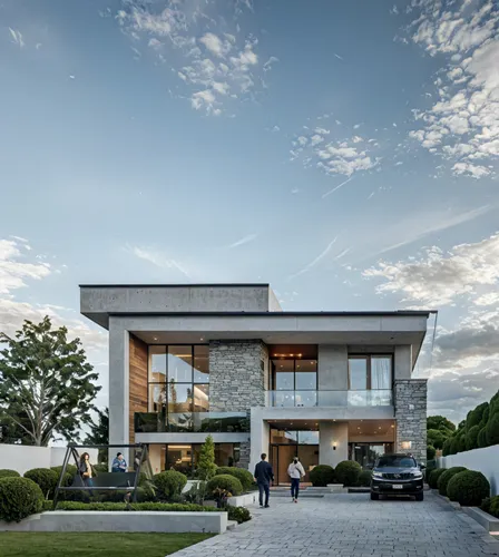 people walking outside a large stone house on the street,modern house,luxury home,modern architecture,dunes house,cube house,beautiful home,luxury property,residential house,crib,large home,contempora