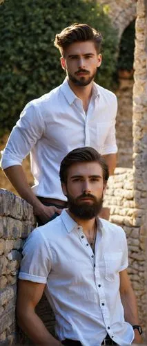 Julian, handsome man, 25yo, short brown hair, stylish beard, blue eyes, casual wear, white shirt, dark jeans, sneakers, relaxed posture, leaning against, stone wall, ancient architecture, Mediterranea