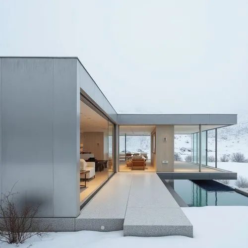 ,a house with its swimming pool in the middle of the snow,snow roof,winter house,snohetta,dunes house,modern house,snow house,pool house,cubic house,cantilevered,modern architecture