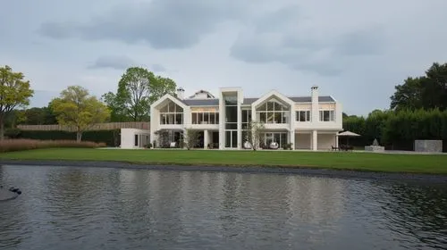 modern contemporary villa ,white exterior walls,a large white building with three stories is on the water,house with lake,luxury home,house by the water,luxury property,modern house,villa,moated,vicar