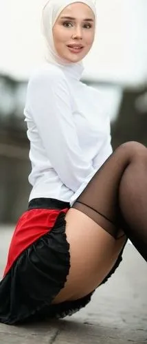 MİNİ ETEK KIRMIZI. SİYAH JARTEYER CORAP, SİYAH TOPUKLU
,a woman is dressed in black and white while sitting on the ground,poppycock,mini,sharia,purdah,halal,miniskirt,ottoman,miniskirts,salaam,hajj,mi