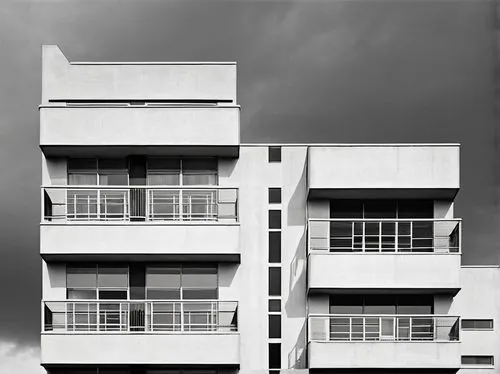 Bauhaus style architecture, modernist building, rectangular shape, clean lines, minimal ornamentation, large windows, steel frames, concrete walls, flat roof, functional balconies, simple door handles