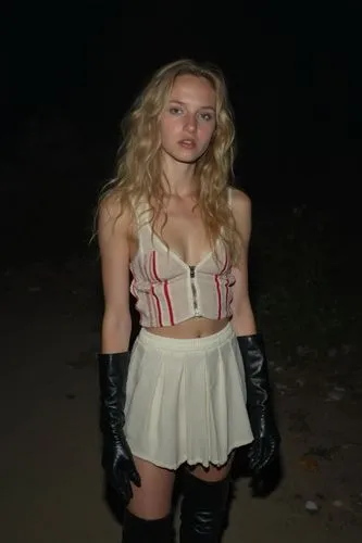 A terribly bad, homemade photo taken late at night in a completely isolated, pitch-black spot where nothing is visible except what the harsh flash hits.

An 18-year-old blonde girl with long wavy hair