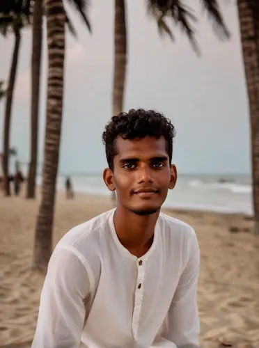 A  beautiful boy sit in beach in goa,beach background,devikund,marathias beach,dhansak,pathiri,kabir,srilanka,bangladeshi taka,pakistani boy,thavil,people on beach,matira beach,india,benagil,khoresh,i