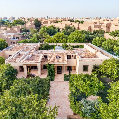 a classic courtyard villas, sustainable modern design in the middle eastern region aerial view,this aerial view shows the expansive yard and trees,martyr village,caravansary,private estate,roof landsc