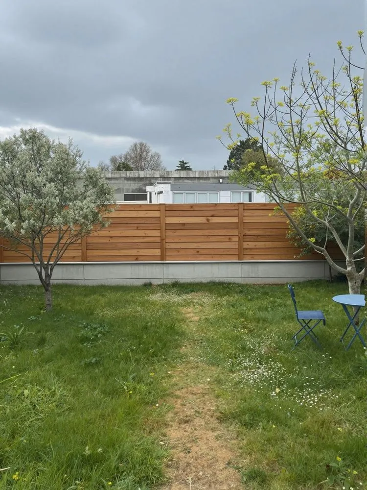 the backyard has a small table and two chairs