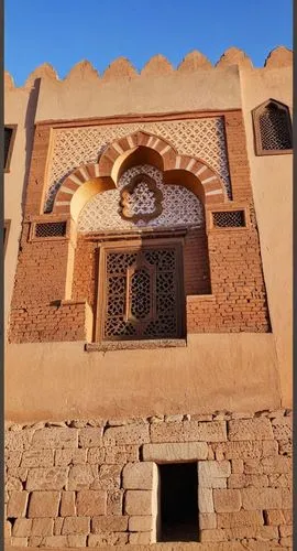an image of the top of a building that looks like a house,morocco,hajji,djellaba,traditional building,stucco frame,alabaster mosque