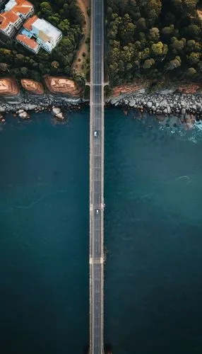 A long wide bridge similar to the Sydney Bridge,an overhead view of a road that runs near the ocean,mavic 2,dubrovnic,harbour bridge,coastal road,canakkale,lesvos,vertiginous,highway bridge,bridge,bos