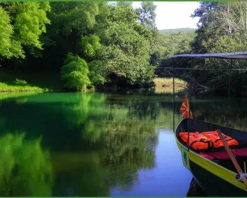 a boat in a green lake,a boat floating on top of a lake surrounded by forest,giverny,the danube delta,dordogne,decebalus,warrandyte,king decebalus,wekiva,danube delta,ardeche,wimberley,bihac,tisza,cen